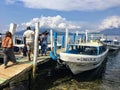 A group of tourists board a boat on Lake Atitlan as they prepare for a tour