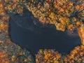 Lake in autumn forest aerial drone view. Trees with colorful orange, red, yellow and green leaves Royalty Free Stock Photo