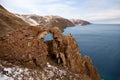 Lake Baikal on a cloudy December day. A mountain landscape, a hole in a rock or a window of desires near Aya Bay Royalty Free Stock Photo