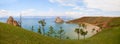 Lake Baikal, Olkhon Island in summer. Panoramic view of Khuzhir Bay and cape Burhan, Shamanka or Shaman Rock. Royalty Free Stock Photo