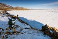 Lake Baikal, Russia - March 8, 2020: Man view from back shows the figure and the bottom turns out to be funny shadowy