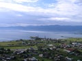 Lake Baikal. A small village on the shore. View from above. In a blue cloudy light