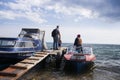 Lake Baikal on a summer day. Listvyanka village. The ship transports tourists. Listvyanka Baikal boats water transport Royalty Free Stock Photo