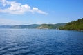 Lake Baikal on a summer day. Listvyanka village. View of the source of the Angara River. Royalty Free Stock Photo