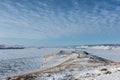 Lake Baikal in winter, ice under snow, hills, sunny day, Siberia