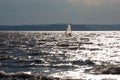 Lake Balaton in backlight with silver waves and a silhouette of a windsurfer Royalty Free Stock Photo