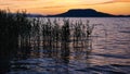 Lake Balaton at sunset with the silhouette of Badacsony hill