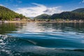 Lake Baykal near green forest mountain and wooden house