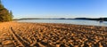 Golden destination place for vacations in summer or autumn season. Touristic beach of golden sand with traces of people at sunset.