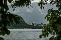 Bled lake with a church Zupnijska cerkev svetega Martina- Church of St. Martina, Bled, in a frame of leaves in summer day time Royalty Free Stock Photo