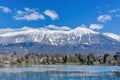 Lake Bled and snow-capped mountains in the background Royalty Free Stock Photo