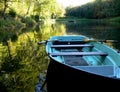 Lake with blue rowing boat and yellow reflection in the water 4 Royalty Free Stock Photo