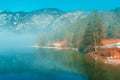 Lake Bohinj landscape in winter morning, fog rising over clean glacial water in slovenian national park Triglav Royalty Free Stock Photo