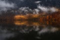 Lake Bohinj, Slovenia. Idyllic Rainy Landscape With Reflection Of Autumn Fiery Red Beech Forest, Mountains, Fisherman`s House And Royalty Free Stock Photo