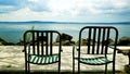 Lake Bracciano from the long lake of Trevignano Romano, with pair of metal chairs in the foreground