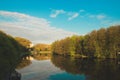 A lake in the city park early in the morning. Quiet and peaceful, in harmony, no people. Fresh green trees and grass, blue sky and Royalty Free Stock Photo