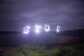 Lake on cloudy night lightpainting of star