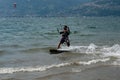 Lake Como, Italy - July 21, 2019. Water sport: kitesurfer riding on a bright sunny summer day near the Colico, town in Italy. Alp