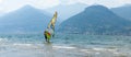 Lake Como, Italy - July 21, 2019. Water sport: windsurfer surfing wind bright sunny summer day near Colico, town in