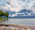 Lake Como (Italy) summer cloudy view with stony shore Royalty Free Stock Photo