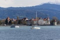 Lake Constance in the Lindau region against the backdrop of the snow-capped Alps. View of the island, the Powder Tower and
