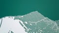 The lake is covered with green ice. The lake freezes. A top view shot with a drone.