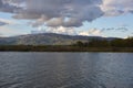 Lake dam landscape with reflection of Gardunha mountains and trees on a cloudy day in Santa Agueda Marateca Dam in Portugal