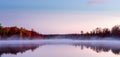 Lake at dawn in autumn with mist in the water