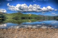 Lake District England beautiful calm sunny summer day at derwent water with reflections and clouds HDR Royalty Free Stock Photo