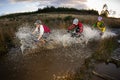 Mountain bikers riding through flooded road