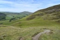 Path winding on hillside with fields below