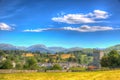 Lake District village Hawkshead Cumbria in summer with blue sky church and red roses in colourful H