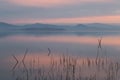 A lake at dusk, with beautiful, warm tones in the sky and water Royalty Free Stock Photo