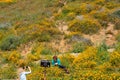 Lake Elsinore, California - March 22, 2019: Tourists clearly disrespecting signs and breaking rules, posing by a Please Stay Off Royalty Free Stock Photo