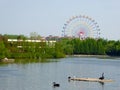 A lake with a Ferris wheel background at Shanghai wild animal park