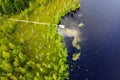 Lake for fishing with wooden pier, aerial view. Mole pier on the lake. Aerial landscape, summer lake shore with dock for boats Royalty Free Stock Photo