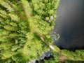 Lake in forest with cloudy sky. Aerial view Russian Karelia. wooden bridge path Royalty Free Stock Photo