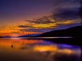 Lake George at sunrise with Loon and clouds Royalty Free Stock Photo