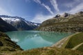 Lake Goeschenen at the Goescheneralp with the dam on the rigth side Royalty Free Stock Photo
