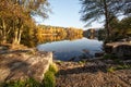 Lake with golden autumn leaves, rocks of a reflection and in the background a hiking pavilion Royalty Free Stock Photo