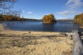 Lake with gravel beach and fall foliage, Mansfield Hollow, Connecticut.