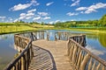 Lake in green nature wooden boardwalk