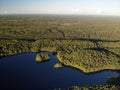 Lake in green summer forest with cloudy sky. Aerial view Russian Karelia. Sunset Royalty Free Stock Photo