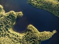 Lake in green summer forest with cloudy sky. Aerial view Russian Karelia. Sunset Royalty Free Stock Photo