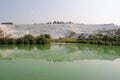 Lake with green water, calcified limestone terraces on background, Pamukkale, Turkey.