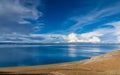 Lake by the hill under blue sky Royalty Free Stock Photo