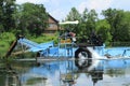 Lake home with vegetation harvester