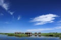 Lake, house, duckweed, blue sky and white clouds Royalty Free Stock Photo