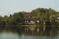 Lake house. house on the shore in the village. landscape with reflection on the water Royalty Free Stock Photo