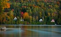 Lake houses line a Vermont pond in peak autumn